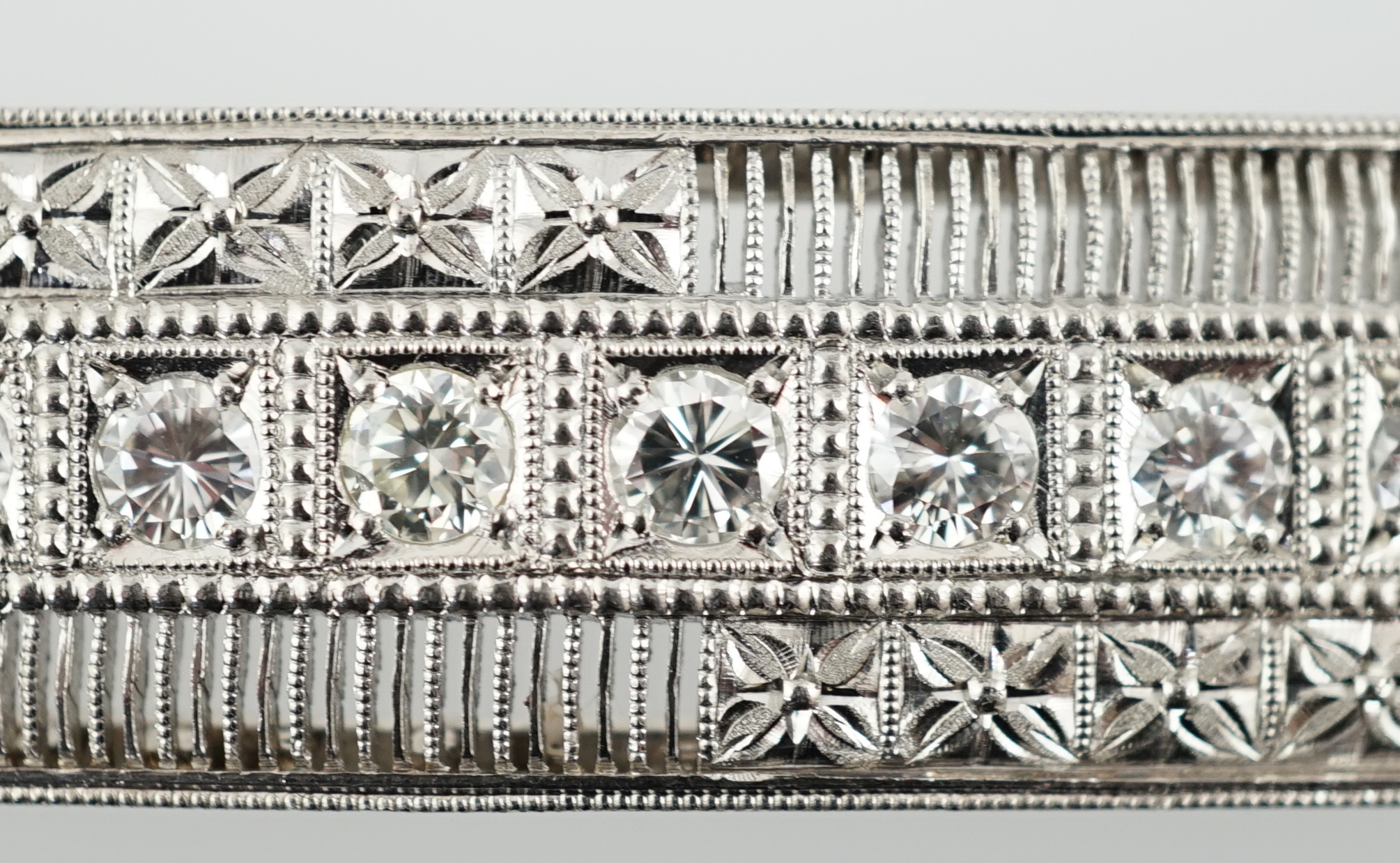 A platinum and eight stone diamond set concave clasp/attachment
